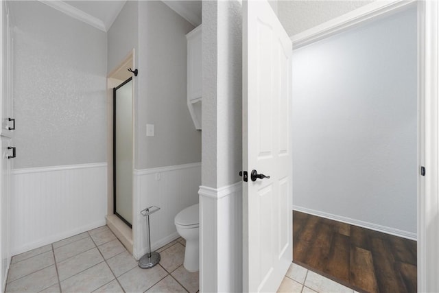 bathroom with toilet, wood-type flooring, and crown molding