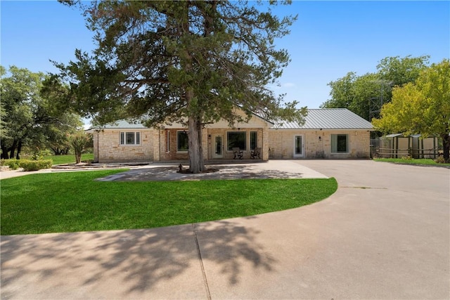 rear view of house featuring a lawn