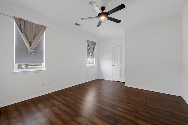 unfurnished room with plenty of natural light, dark hardwood / wood-style flooring, and ornamental molding