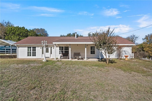 rear view of house with a yard and a patio