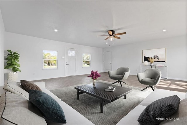 living room with hardwood / wood-style floors and ceiling fan