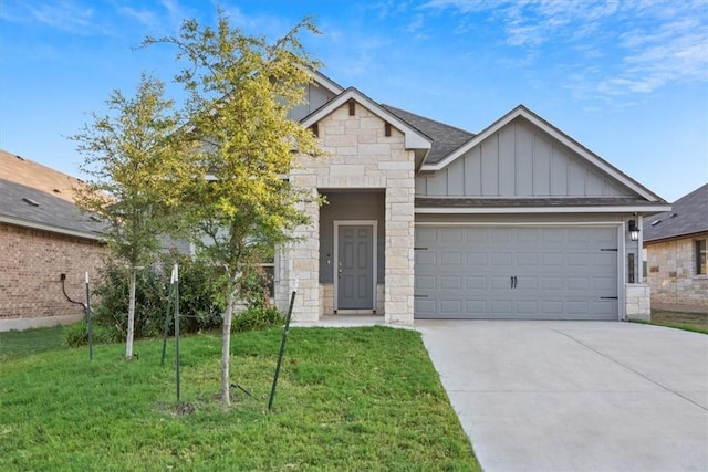 view of front of property with a front yard and a garage