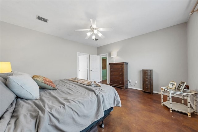 bedroom featuring finished concrete flooring, baseboards, visible vents, and a ceiling fan