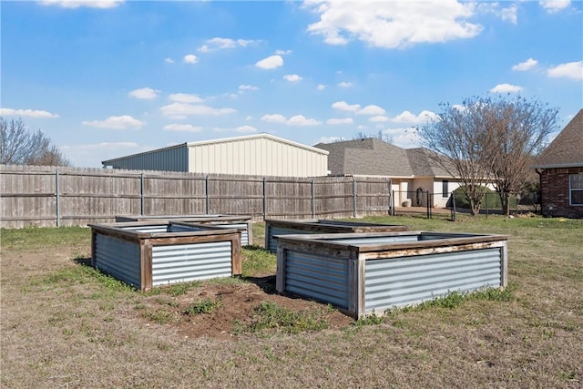 view of yard with fence and a vegetable garden