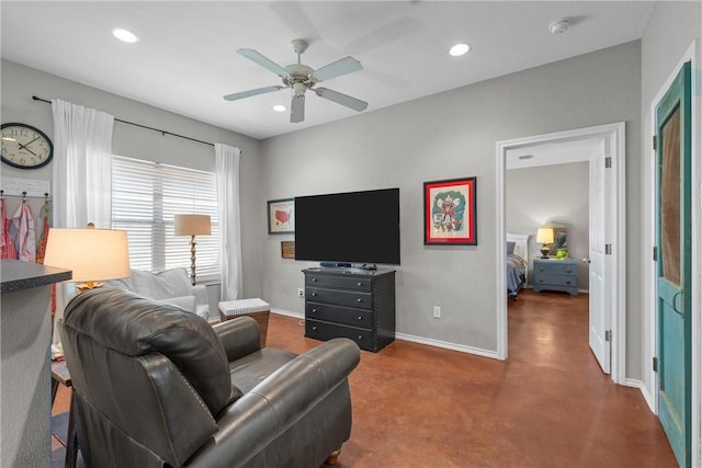 living area featuring baseboards, a ceiling fan, and recessed lighting