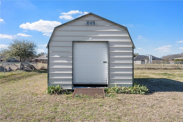 view of shed featuring fence