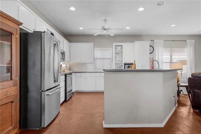 kitchen featuring finished concrete flooring, appliances with stainless steel finishes, white cabinets, and recessed lighting