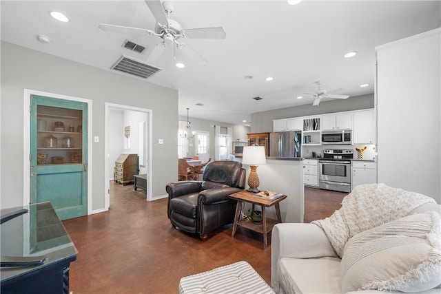 living room with recessed lighting, visible vents, concrete floors, and ceiling fan with notable chandelier