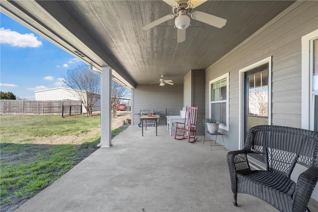 view of patio / terrace with a ceiling fan and fence