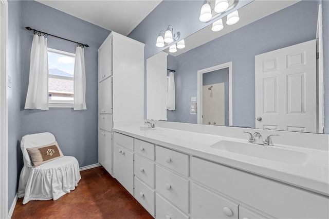 full bath featuring a sink, baseboards, and double vanity