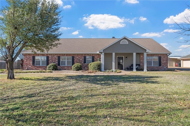 view of front facade with brick siding and a front lawn