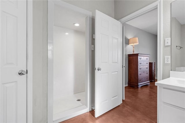 full bathroom with a shower, concrete floors, and vanity