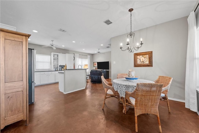 dining area featuring finished concrete flooring, ceiling fan with notable chandelier, visible vents, and recessed lighting