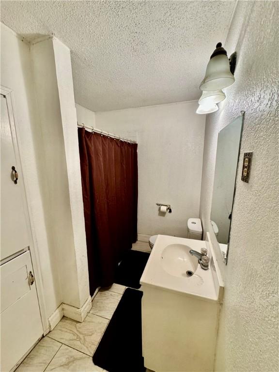 bathroom featuring vanity and a textured ceiling