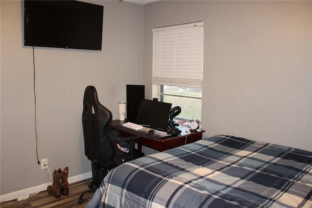 bedroom with dark hardwood / wood-style flooring