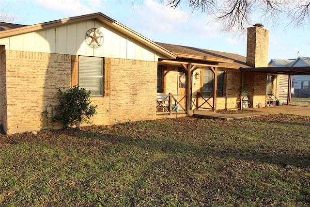 back of property featuring a yard