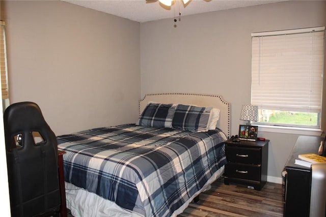 bedroom featuring dark hardwood / wood-style floors and ceiling fan