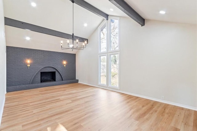 unfurnished living room featuring a fireplace, a chandelier, light hardwood / wood-style flooring, and lofted ceiling with beams