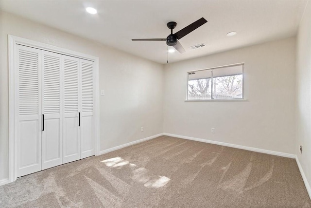 unfurnished bedroom featuring carpet, a closet, and ceiling fan