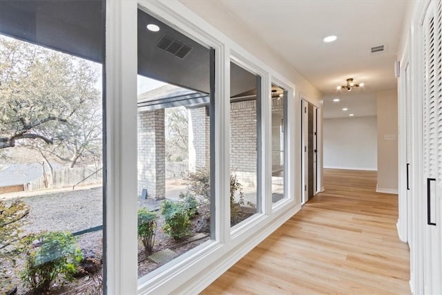 corridor featuring light hardwood / wood-style floors