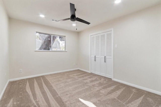 unfurnished bedroom with carpet flooring, ceiling fan, and a closet