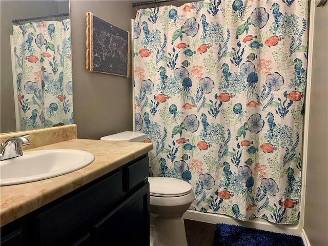 bathroom with a shower with curtain, toilet, and vanity