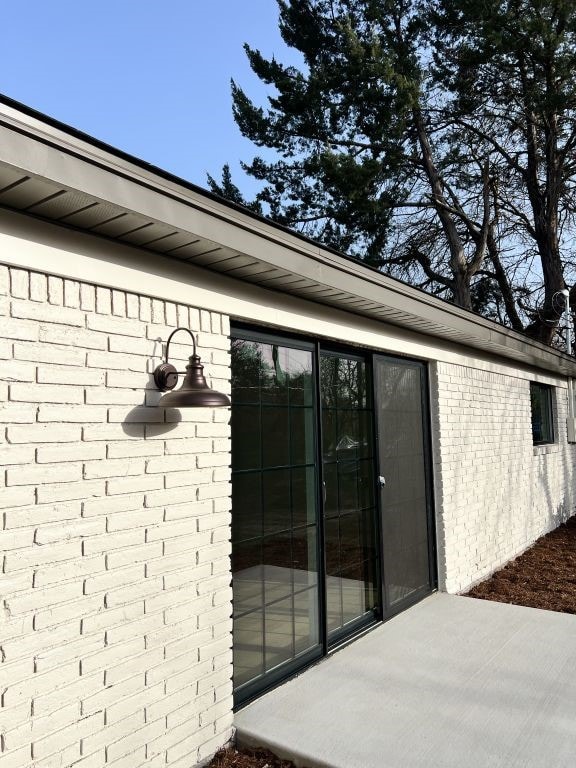 property entrance with brick siding