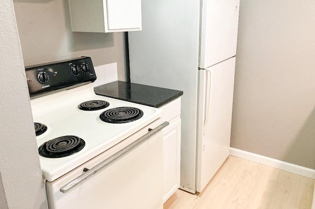 kitchen featuring white cabinets, white range with electric stovetop, and light wood-type flooring