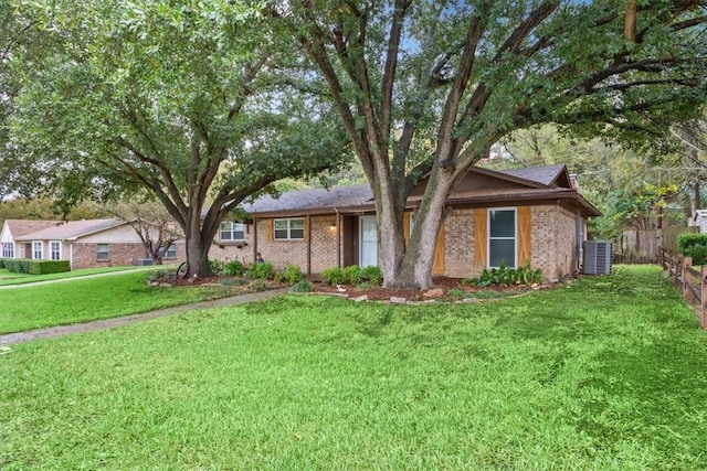 ranch-style home with a front yard and cooling unit