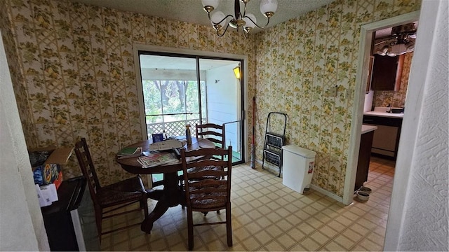 dining room featuring a textured ceiling and a notable chandelier