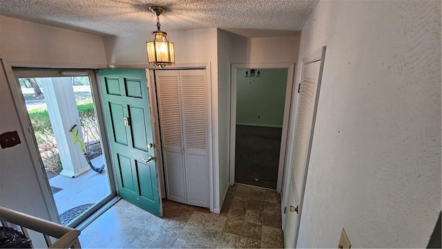 foyer featuring a textured ceiling