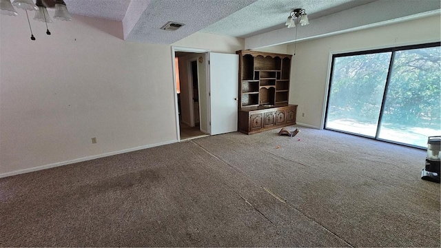 unfurnished living room with a textured ceiling and carpet floors