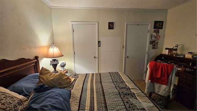 bedroom with a textured ceiling, a closet, and ornamental molding