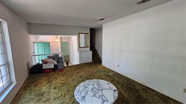 interior space with carpet and a textured ceiling