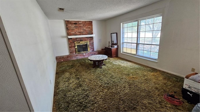 carpeted living room featuring a fireplace and a textured ceiling