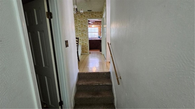 stairway featuring tile patterned floors