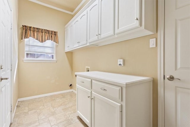 clothes washing area with washer hookup, ornamental molding, and cabinets