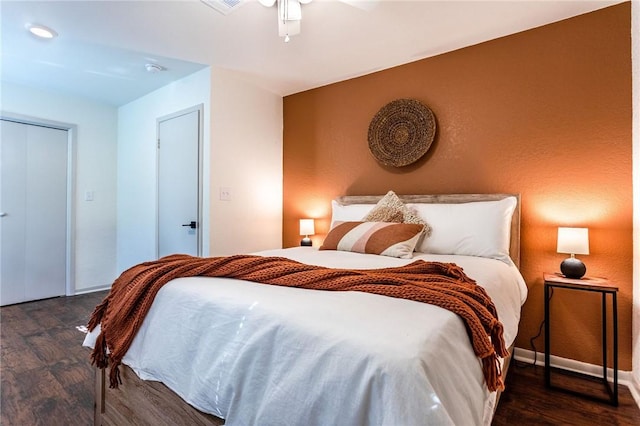 bedroom featuring ceiling fan and dark wood-type flooring