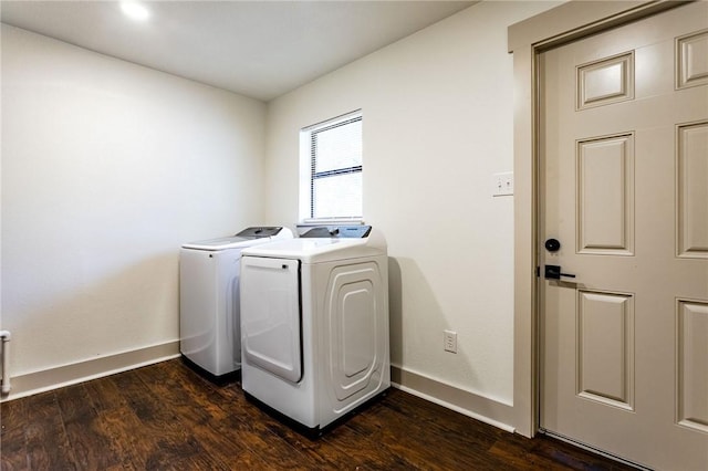 laundry room with dark hardwood / wood-style floors and washing machine and clothes dryer