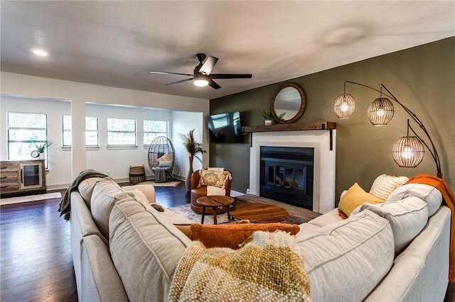 living room featuring dark hardwood / wood-style floors and ceiling fan