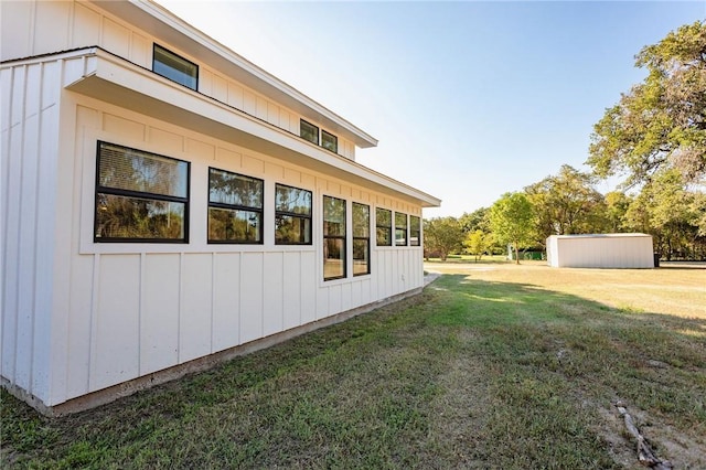 view of side of home with a yard