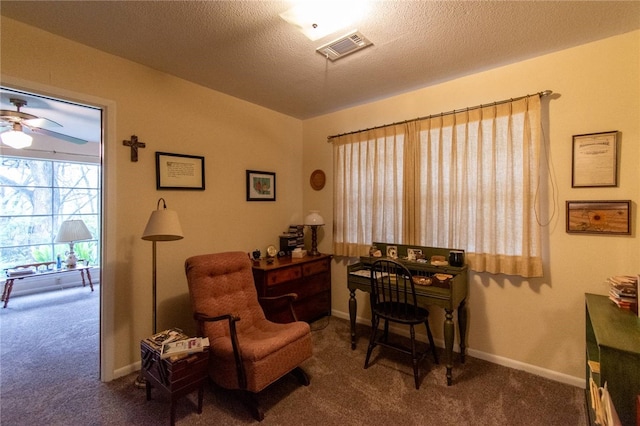 sitting room featuring carpet flooring, ceiling fan, and a textured ceiling