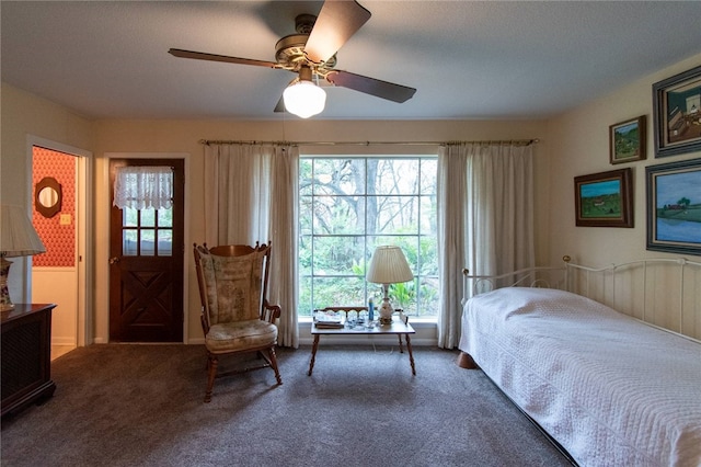 bedroom with ceiling fan and dark carpet