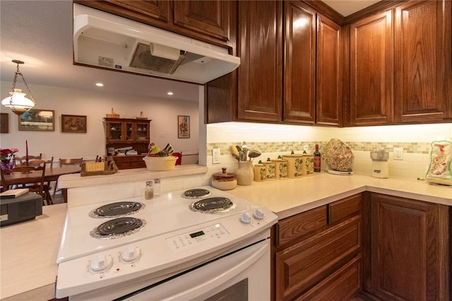 kitchen with tasteful backsplash, white range with electric cooktop, and hanging light fixtures