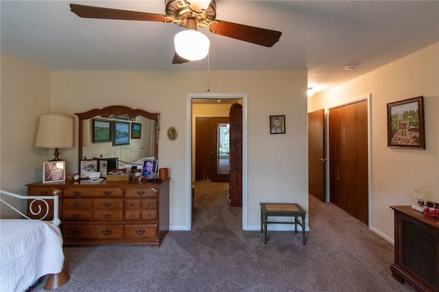 bedroom featuring ceiling fan and dark carpet