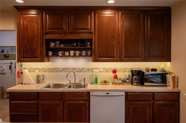 kitchen featuring dishwasher, decorative backsplash, and sink