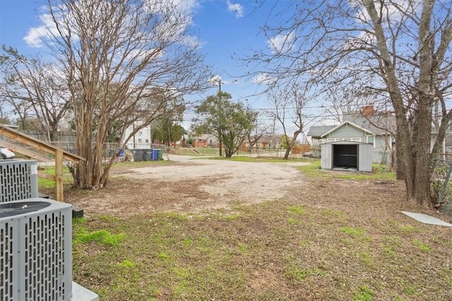 view of yard featuring an outdoor structure and central AC unit