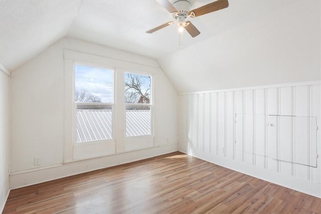 additional living space with ceiling fan, hardwood / wood-style floors, and vaulted ceiling