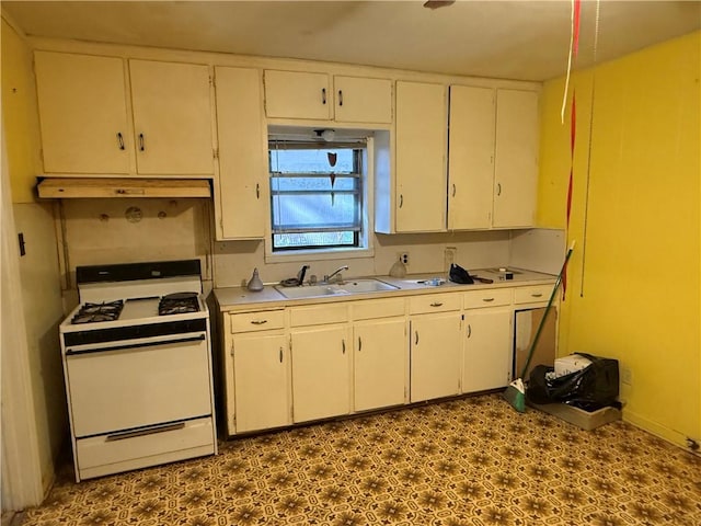 kitchen featuring white cabinetry, white gas range, and sink