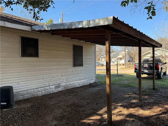 view of home's exterior with central AC unit and a carport